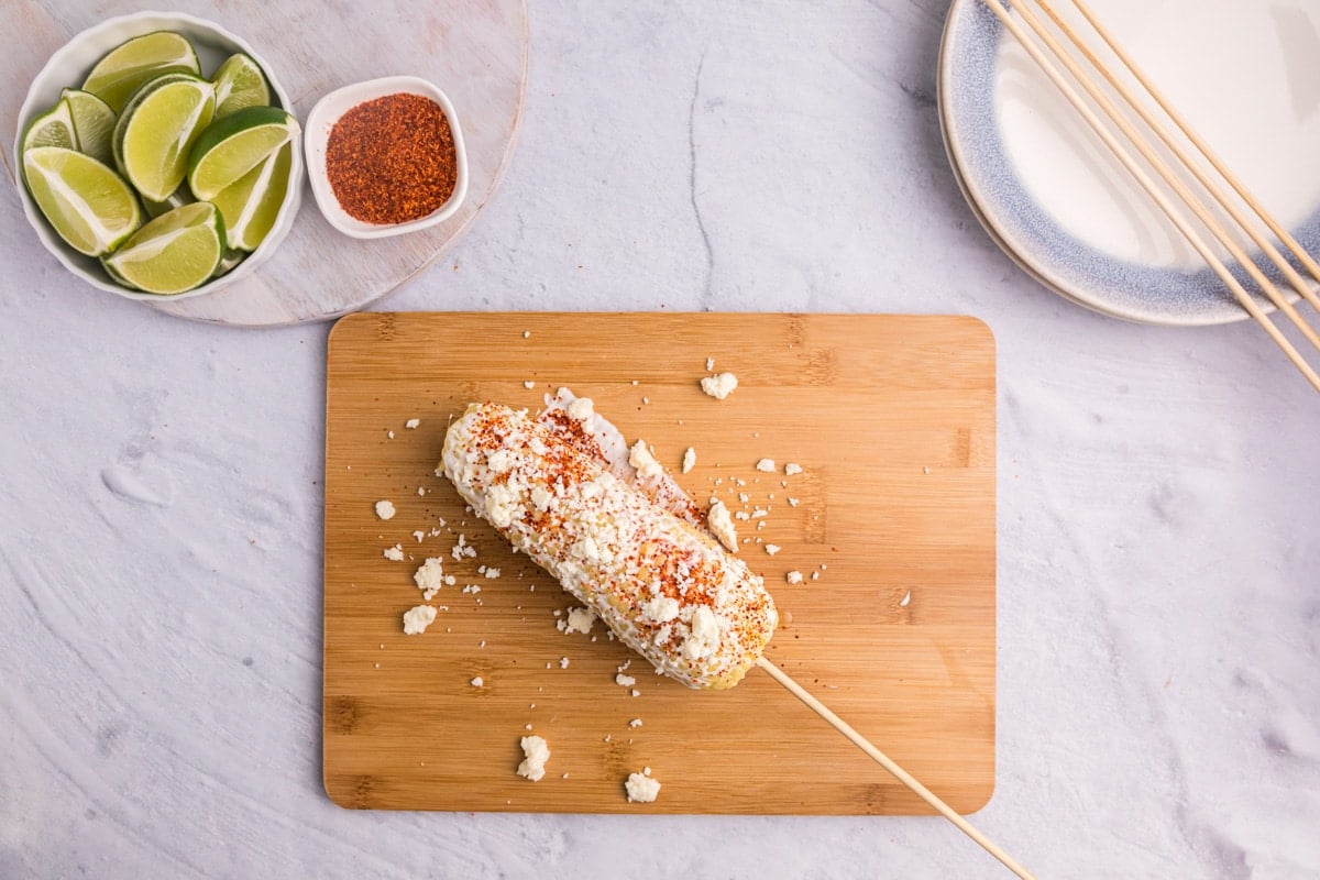 cotija and tajin on an ear of corn