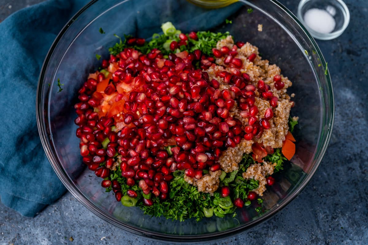 pomegranate, bulgur wheat and parlsey in a glass bowl