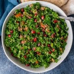 an overhead view of parsley salad in a bowl with a a spoon