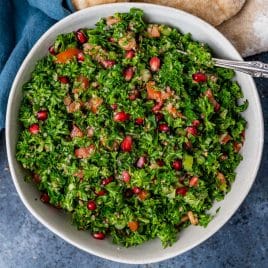 an overhead view of parsley salad in a bowl with a a spoon