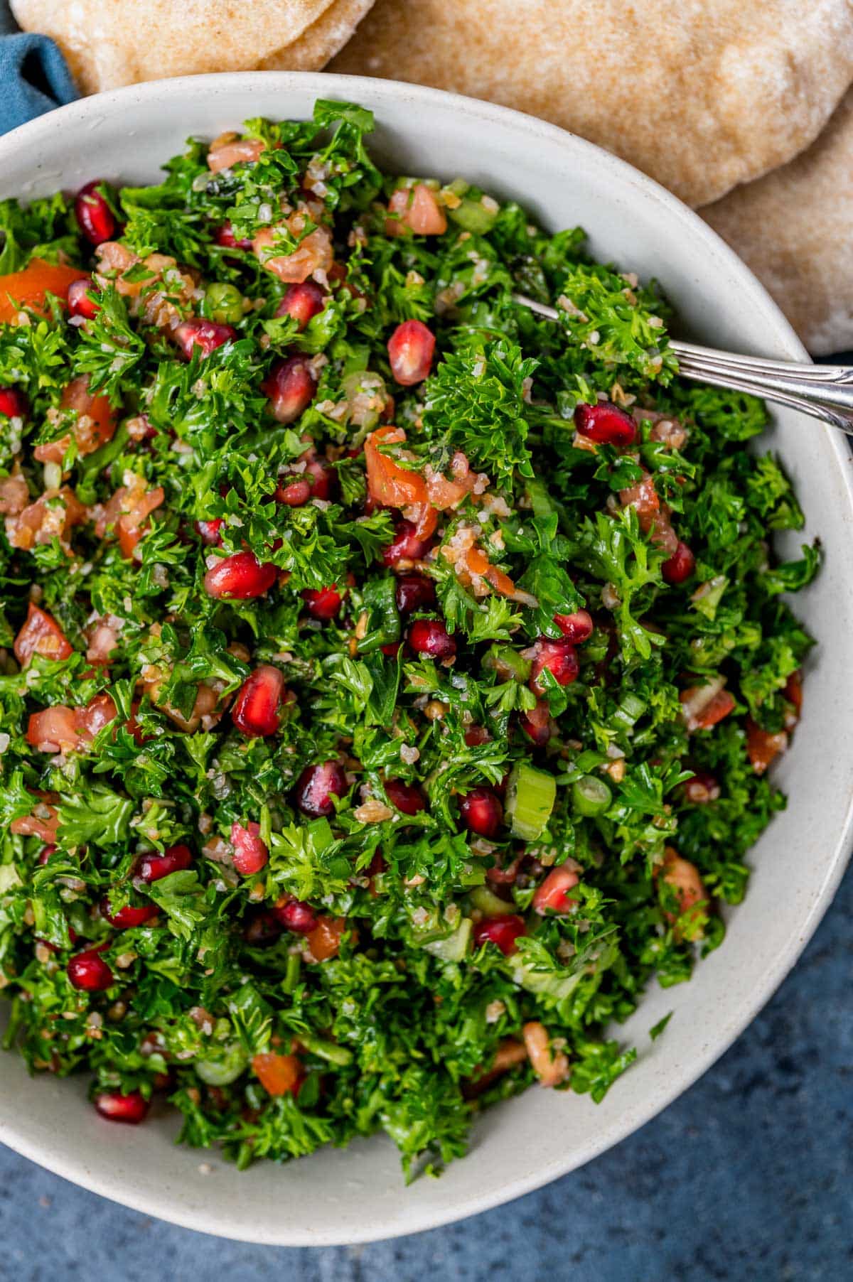 a bowl of tabbouleh with pomegranate in it