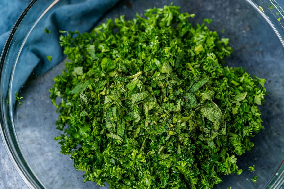 fresh parsley and green onion in a glass bowl