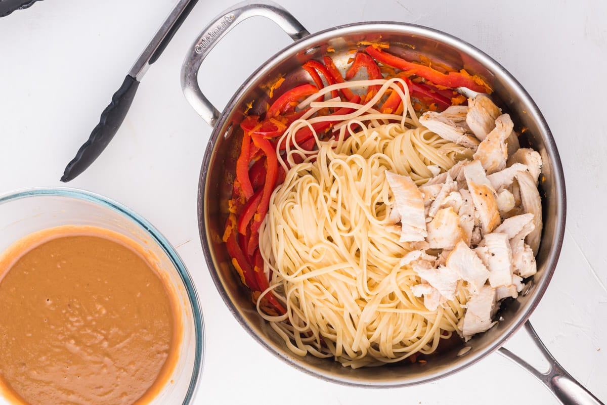 peppers, noodles and chicken in a skillet