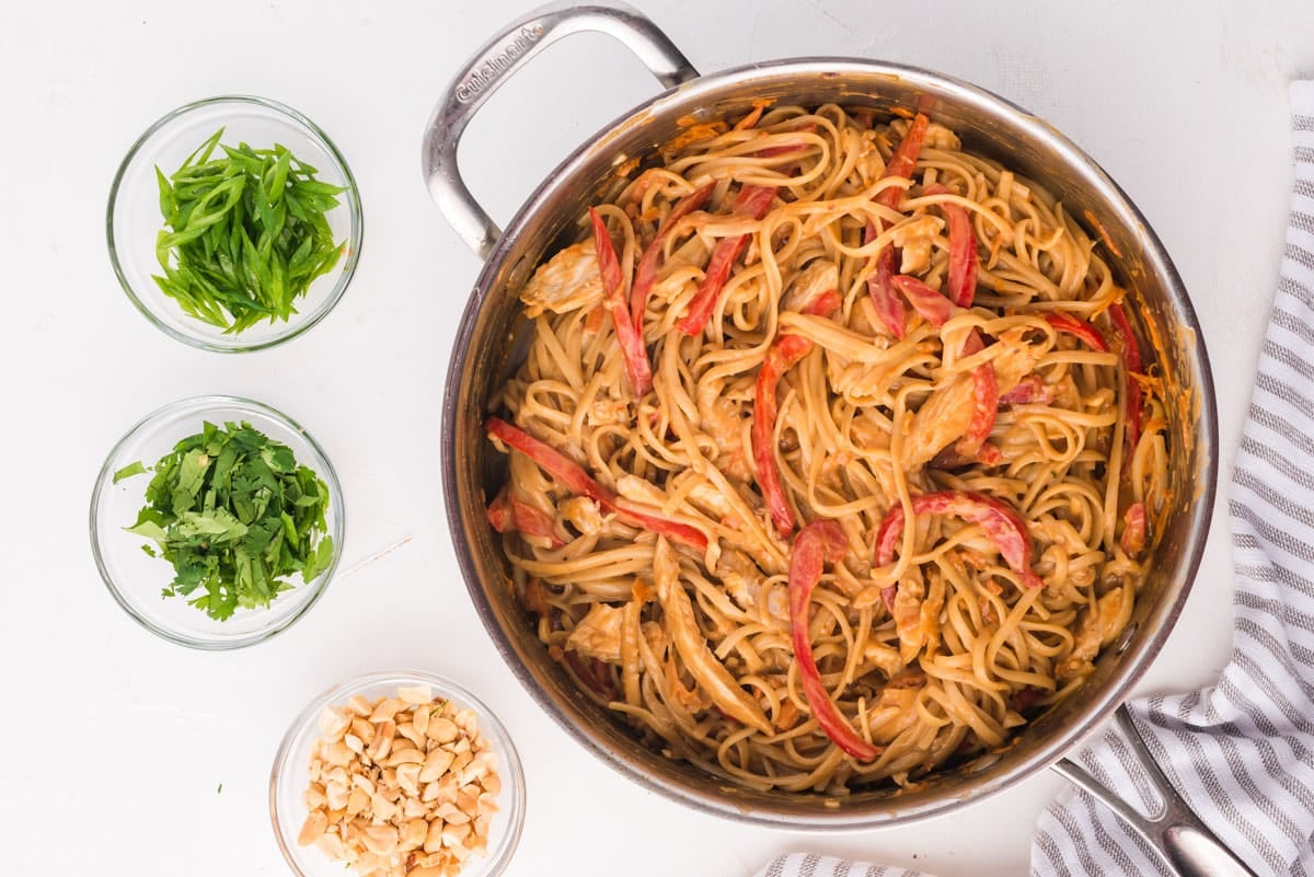 peanut noodles with chicken in a skillet