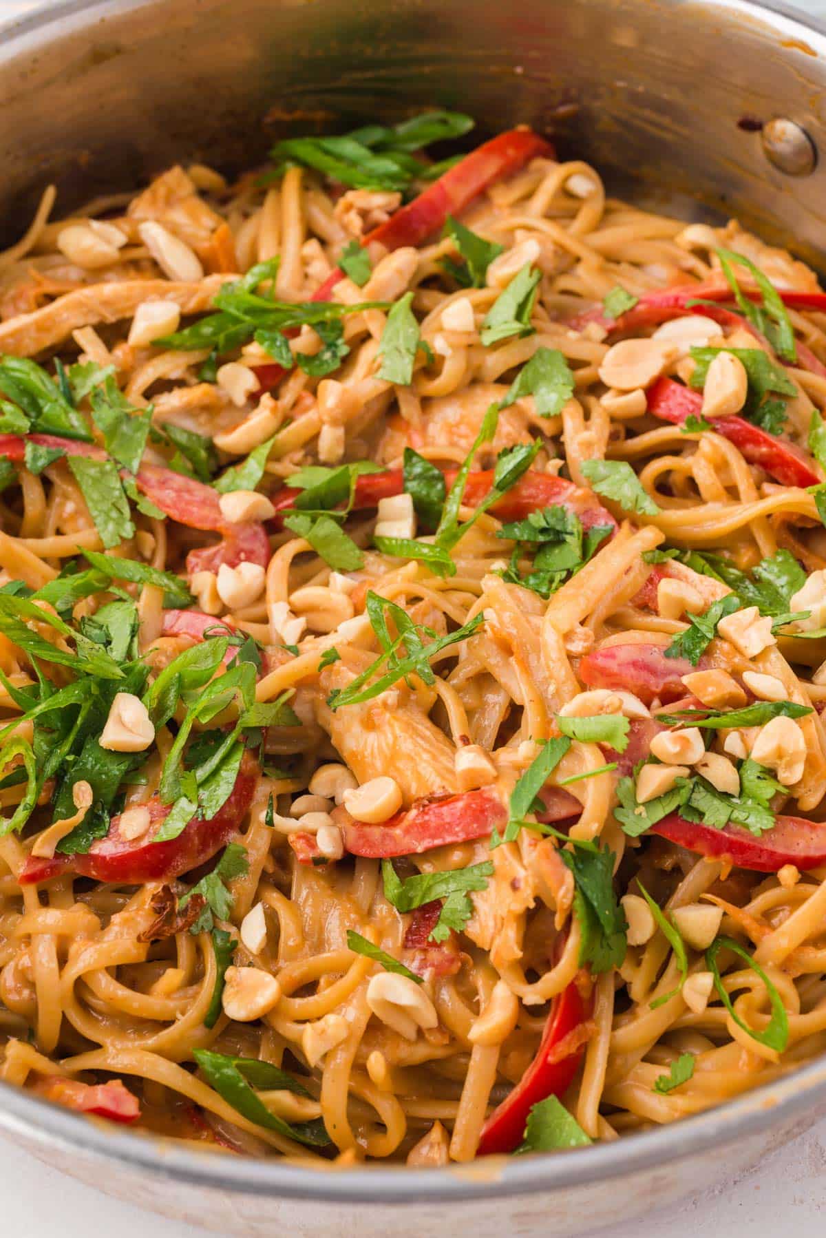 closeup of thai peanut noodles in a skillet