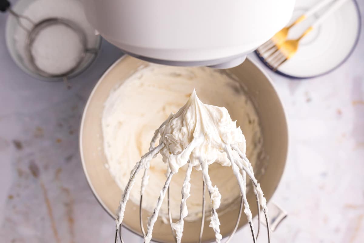 whipped frosting on a stand mixer whisk