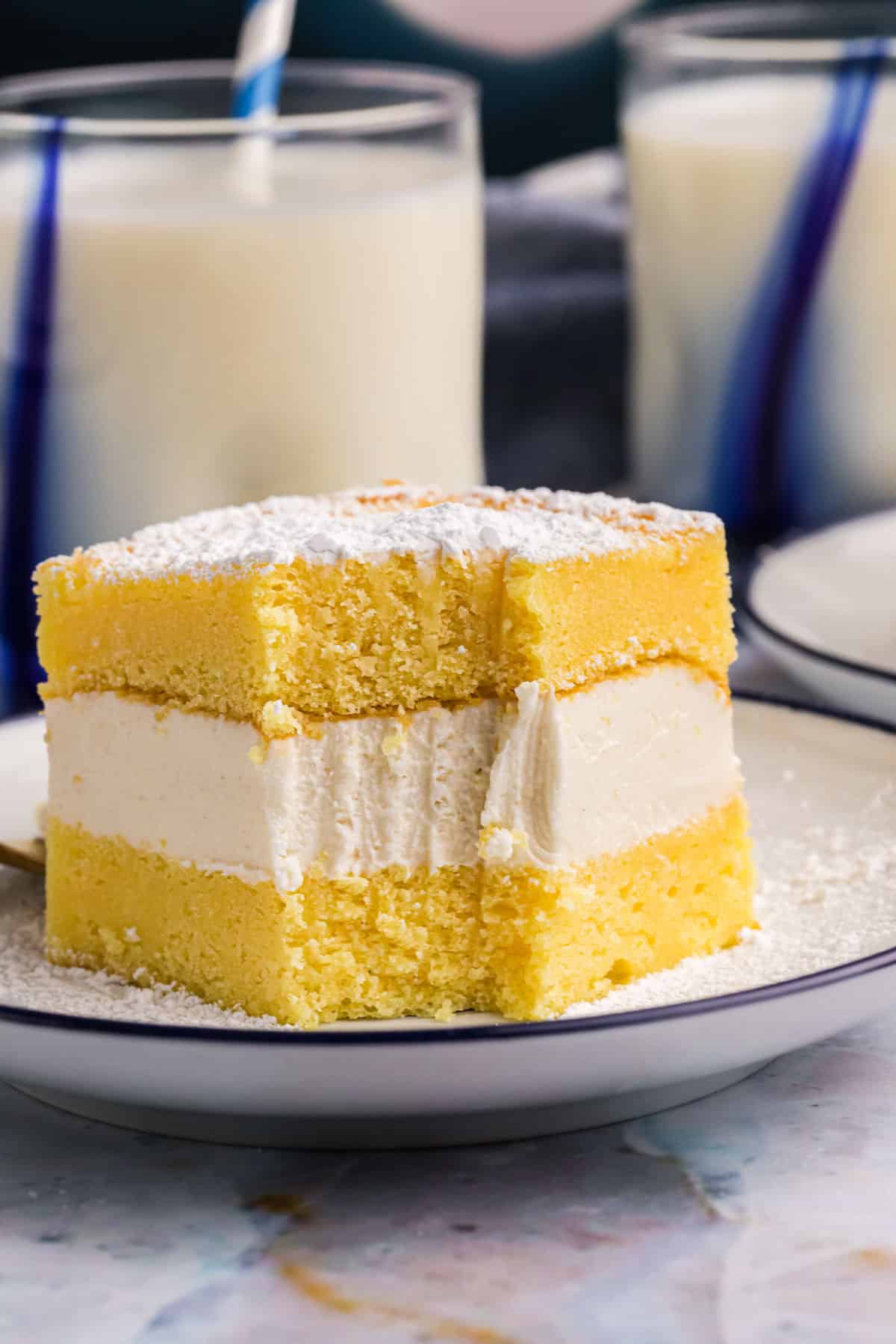a piece of yellow layer twinkie cake on a plate with a bite out
