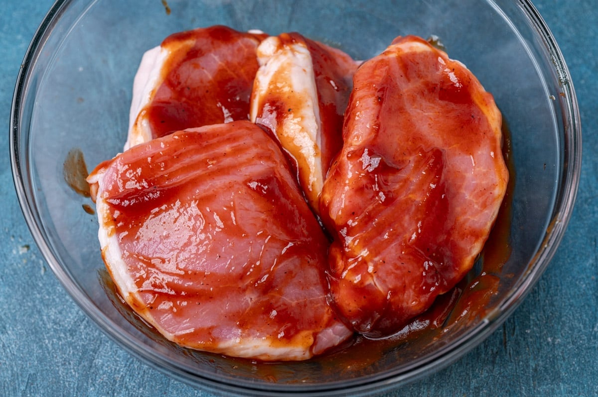 bbq pork chops marinating in a bowl