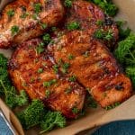 closeup of grilled bbq pork chops with parsley on top