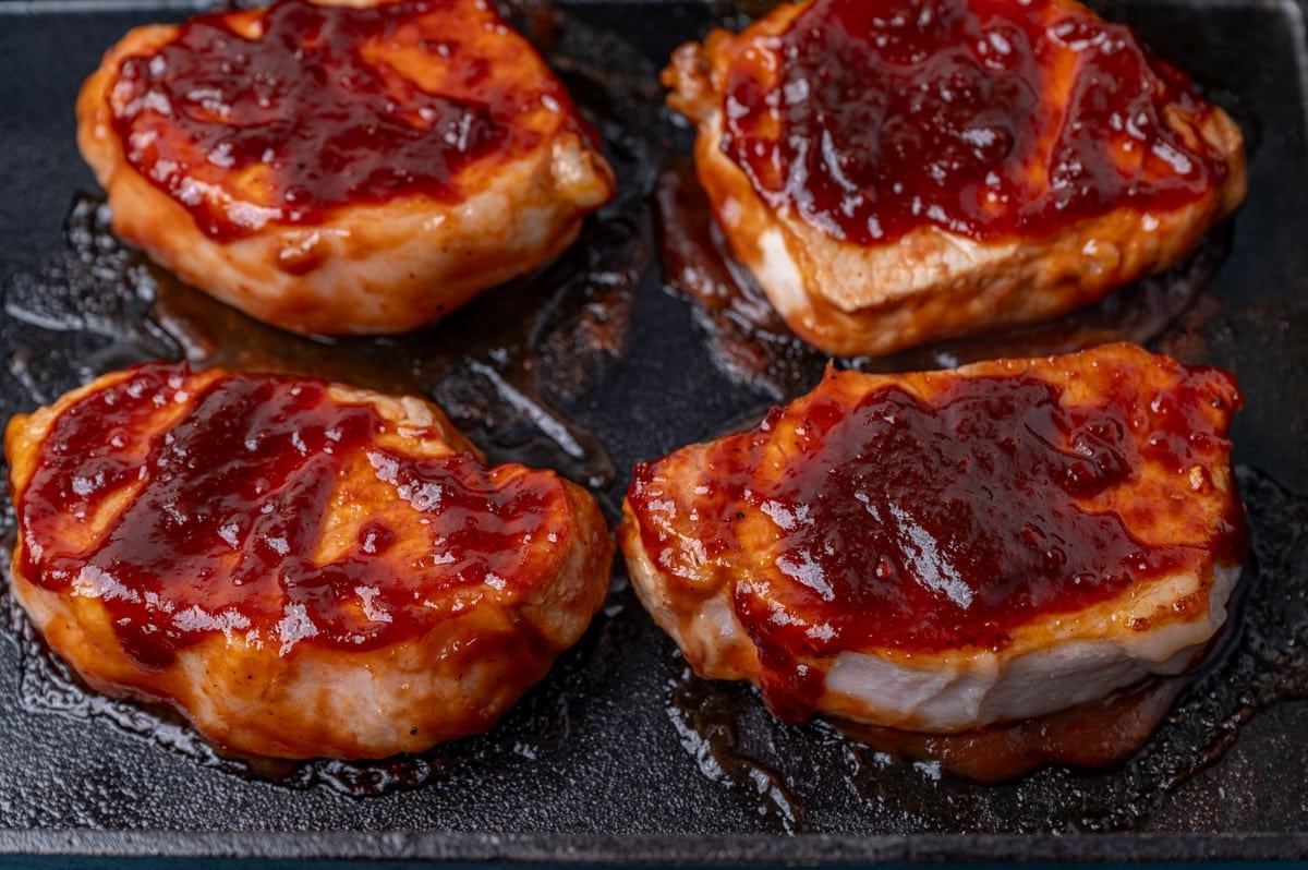 pork chops with bbq sauce in a baking pan