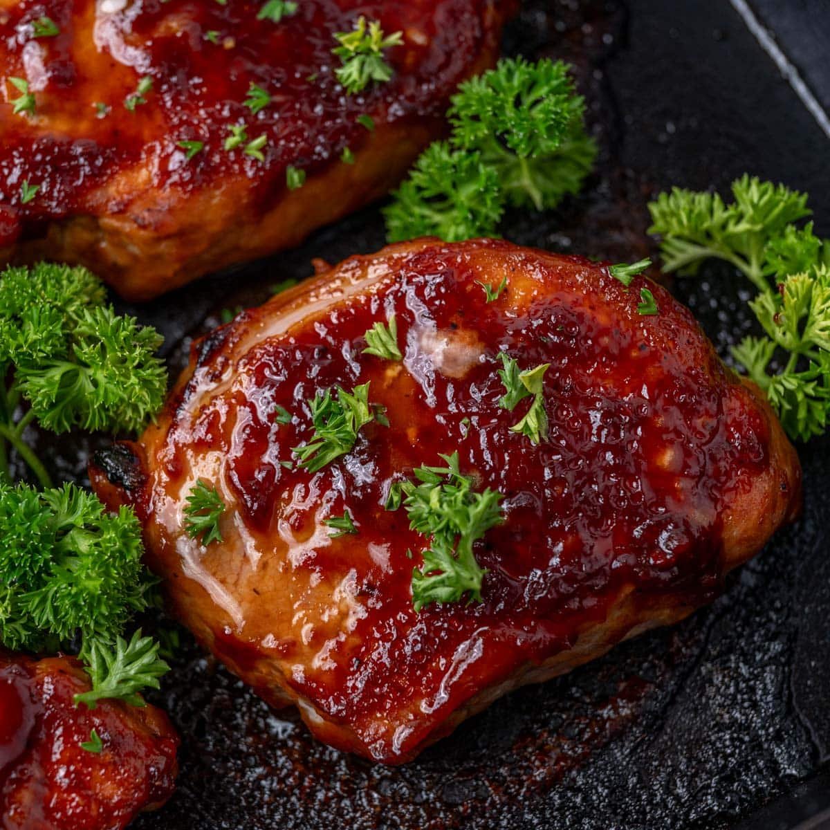 bbq pork chops baked in a cast iron skillet