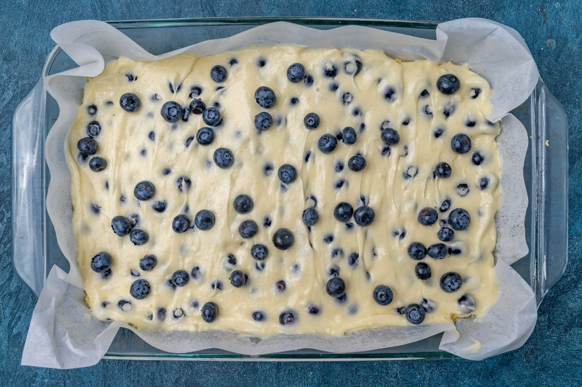 unbaked blueberry lemon gooey butter cake in a pan