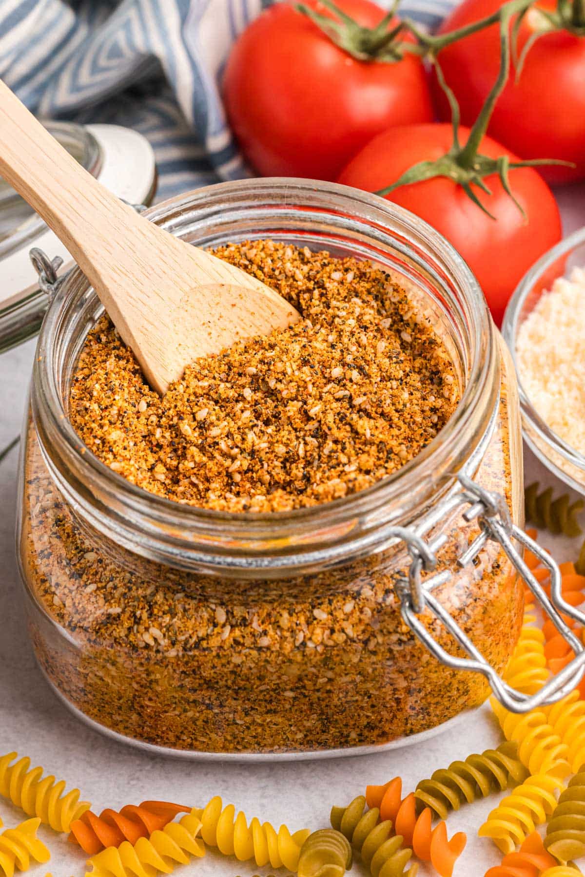 a wooden spoon in a jar of pasta salad seasoning mix