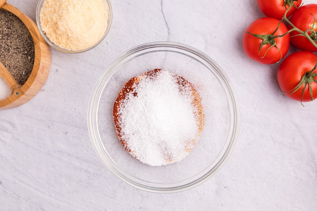 salt over seasonings in a glass bowl