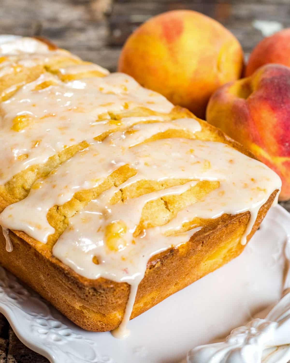 a loaf of glazed peach bread on a table