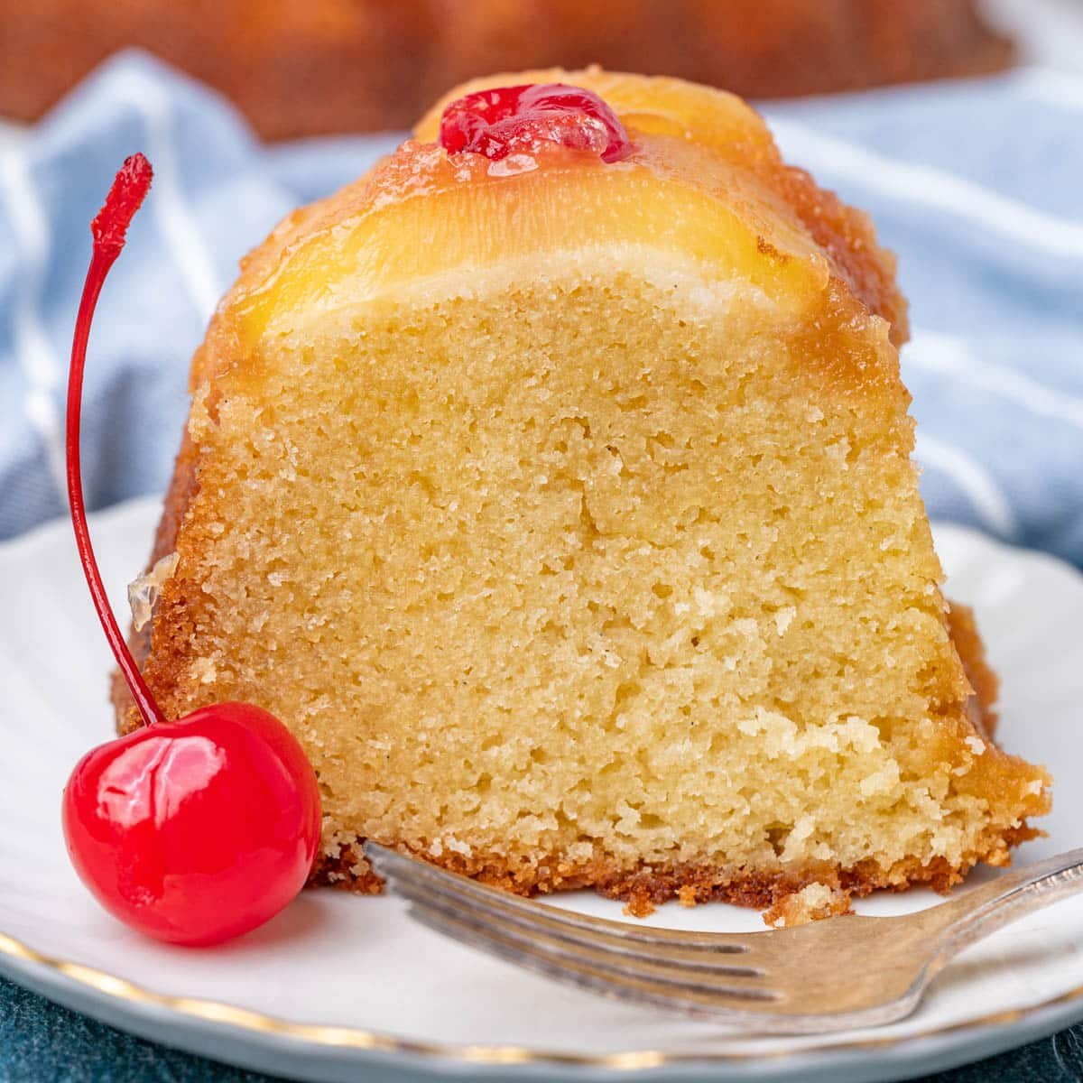 a slice of pineapple upside down bundt cake on a plate