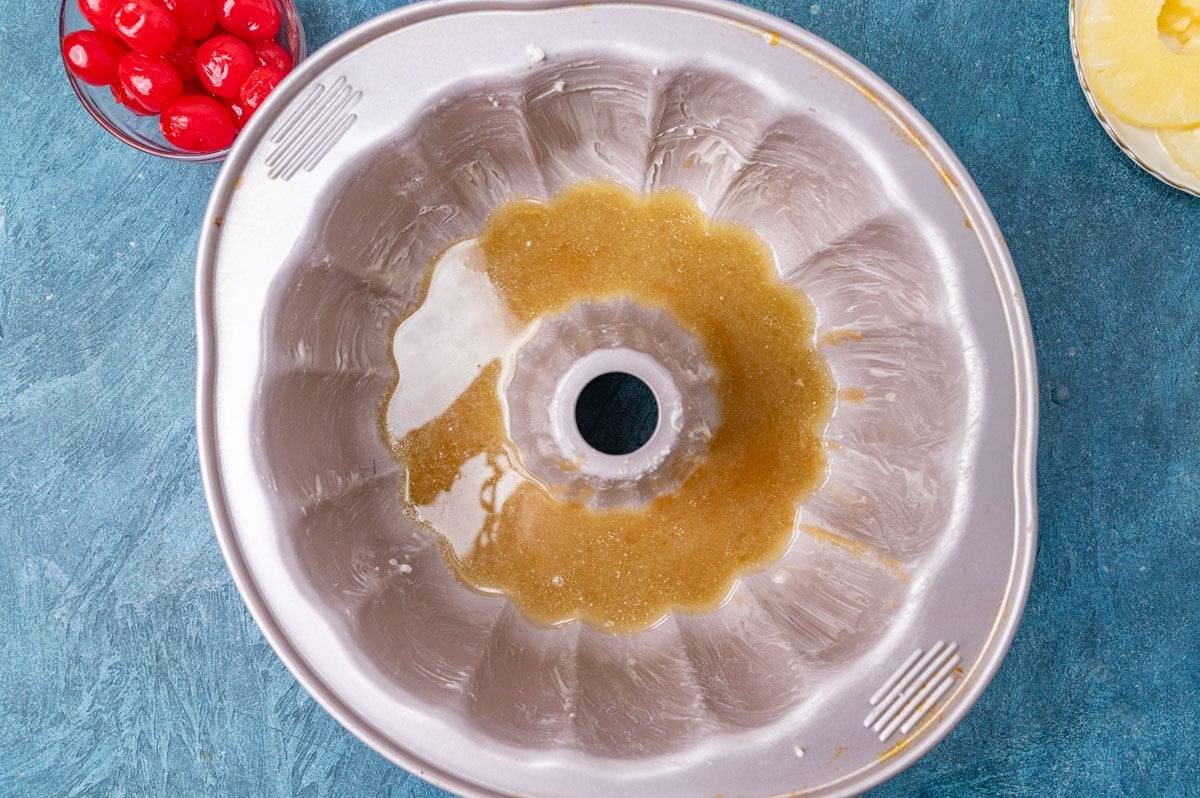 bundt cake pan with brown sugar and butter in the bottom
