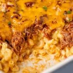 closeup of pulled pork mac and cheese in a casserole pan