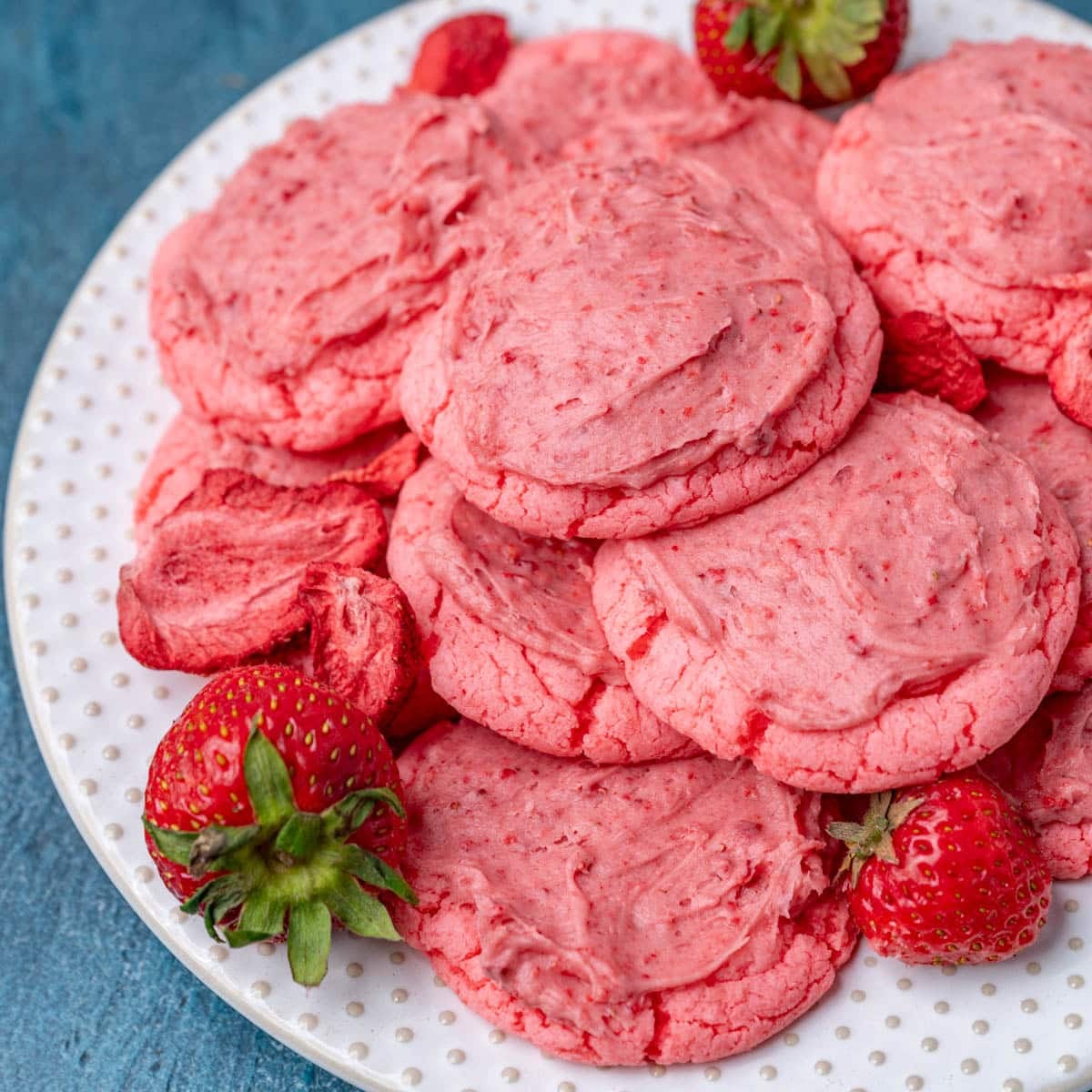 a plate of frosted strawberry cookies