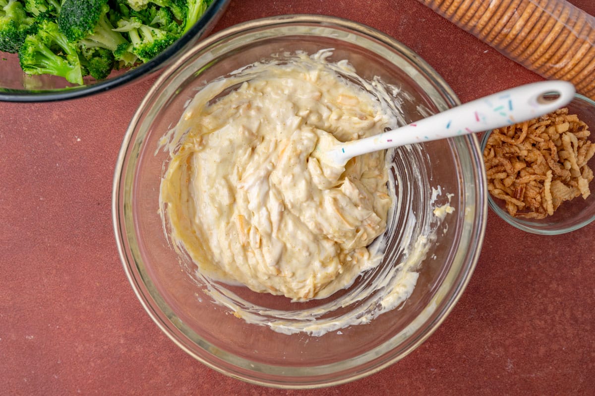 mayo and cheese mixture in a glass bowl with a spatula