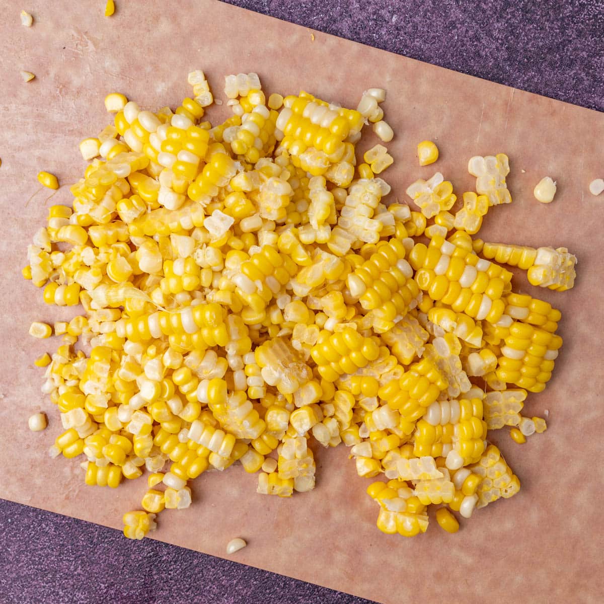 sweet corn cut off the cob on a cutting board