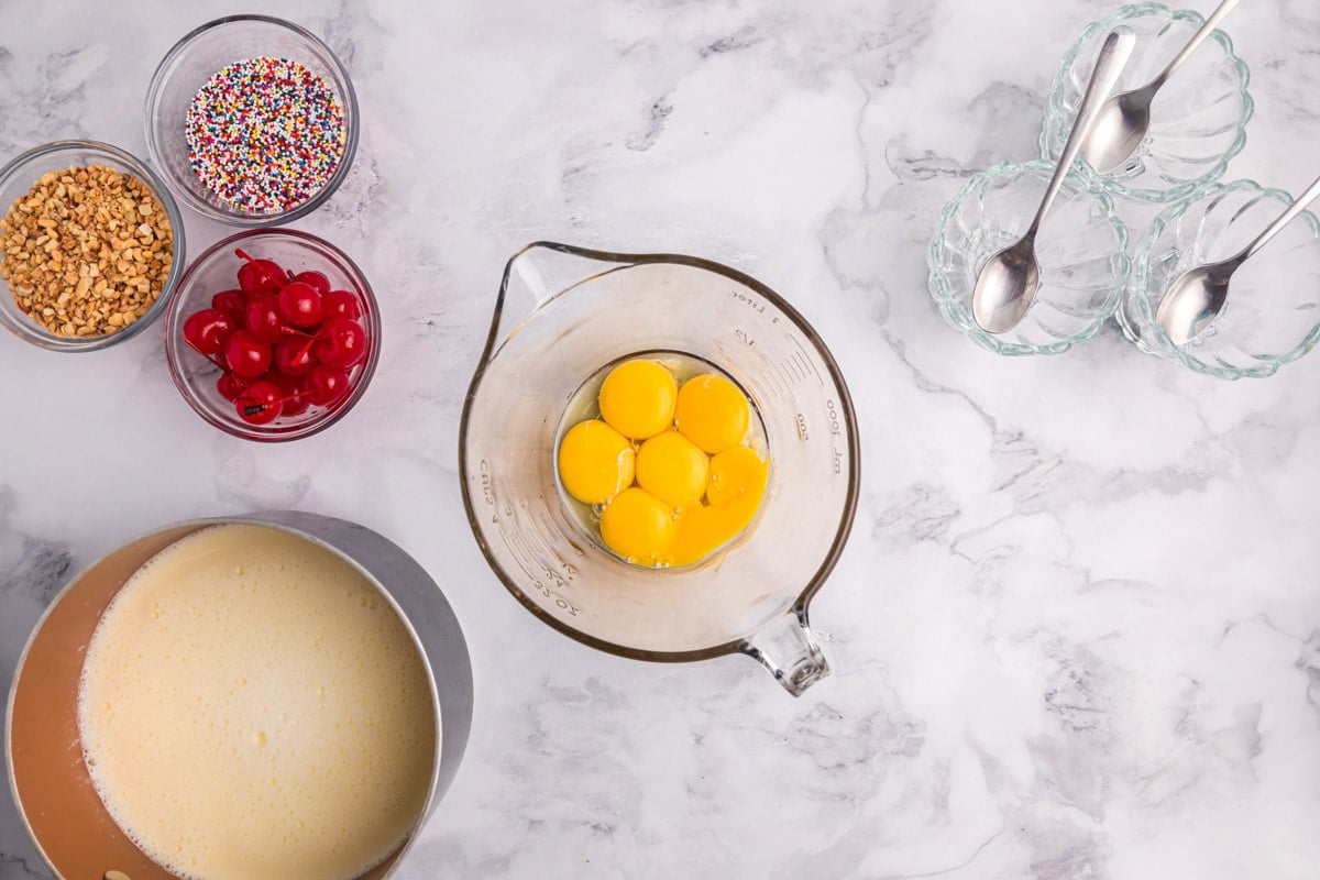 egg yolks in a glass bowl on a table