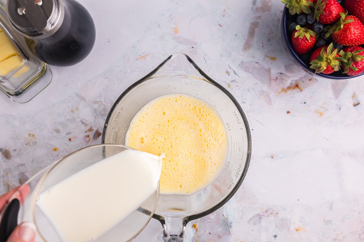 milk pouring into whipped eggs