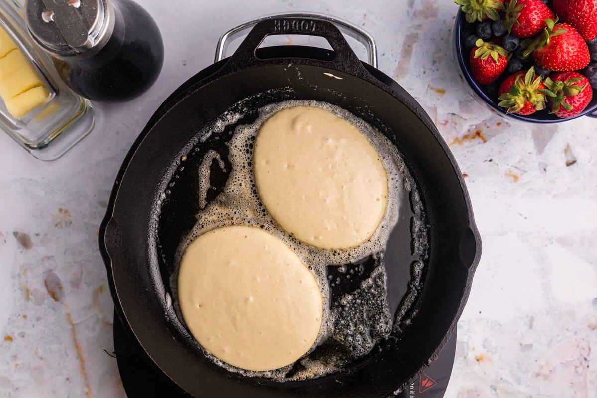 two pancakes in a cast iron skillet