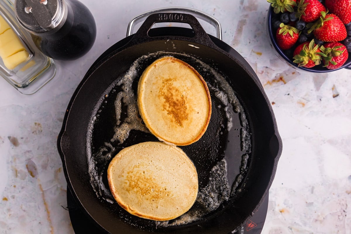 two pancakes in a cast iron skillet