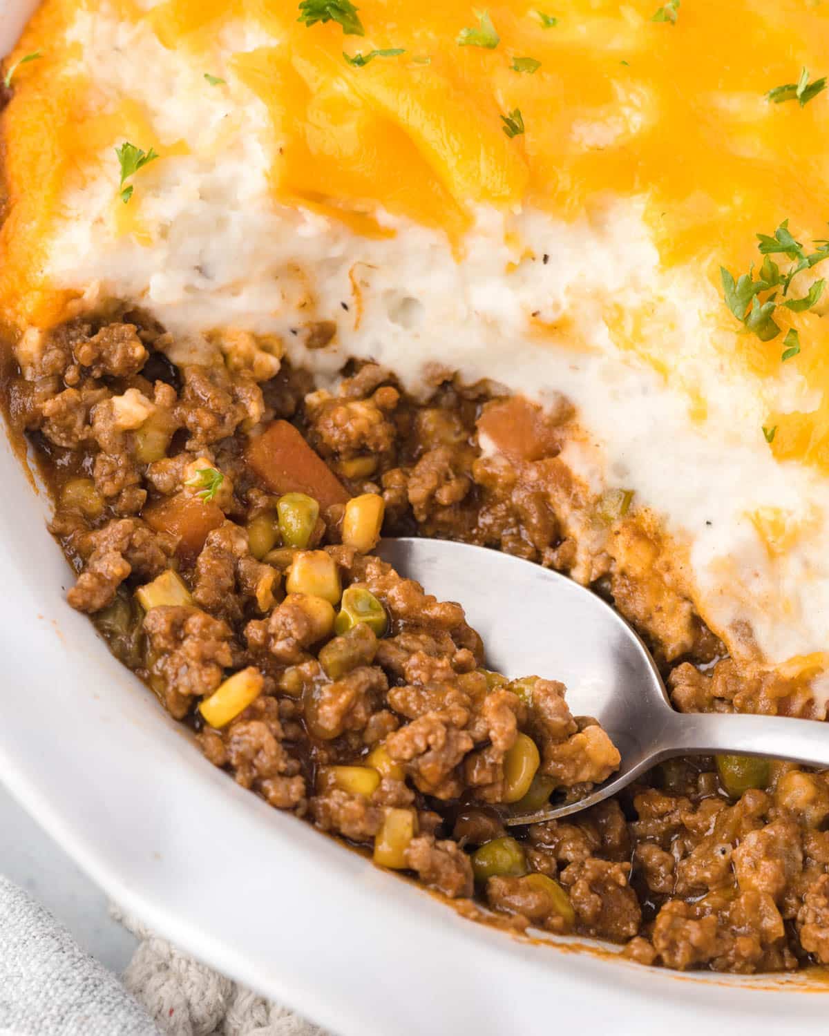 cottage pie with ground beef and a spoon in it