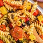closeup of Italian pastas salad with a wooden spoon in the bowl