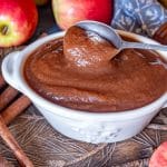 a bowl of apple butter with a spoon