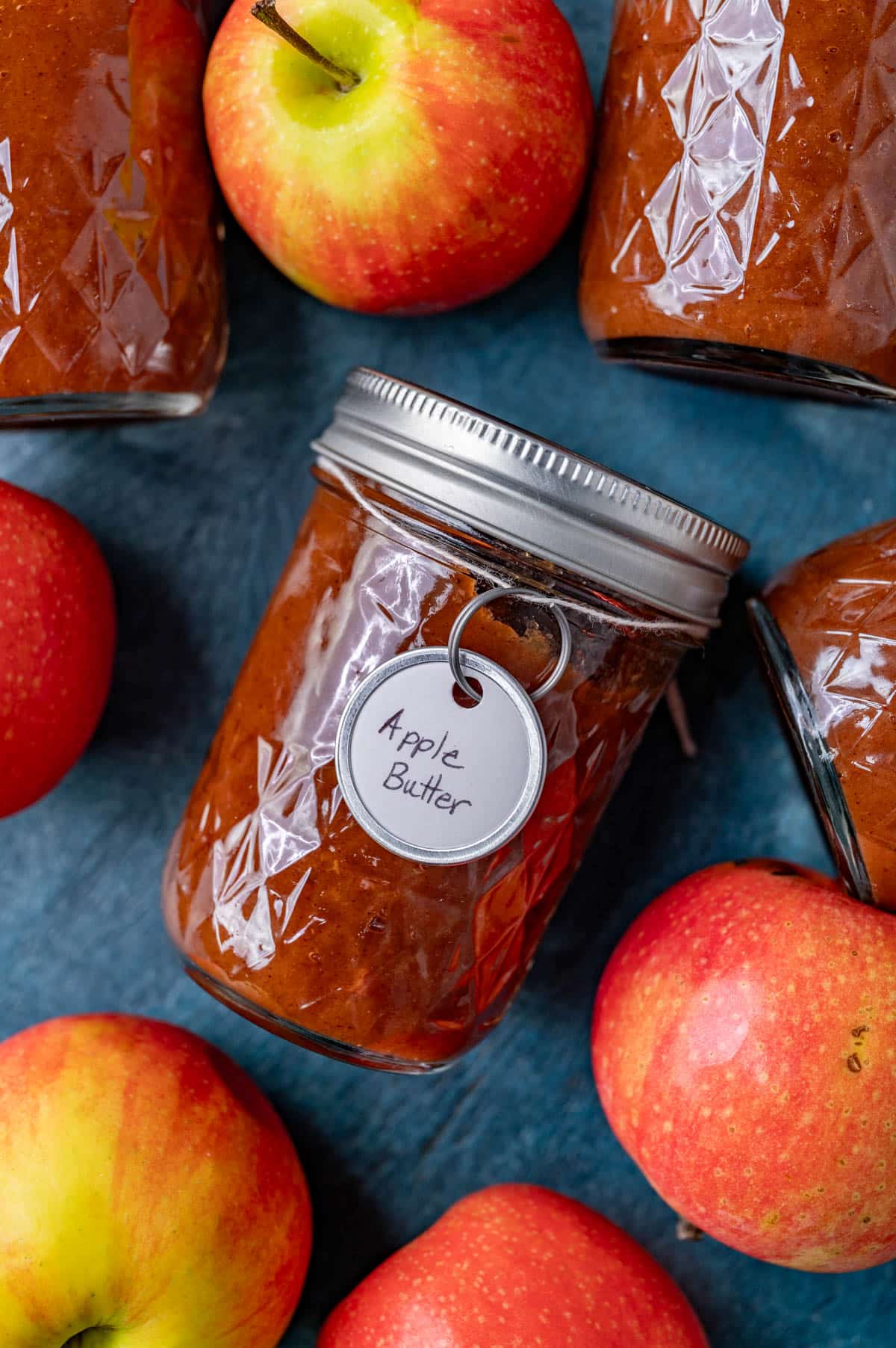 apple butter jars and apples on a table