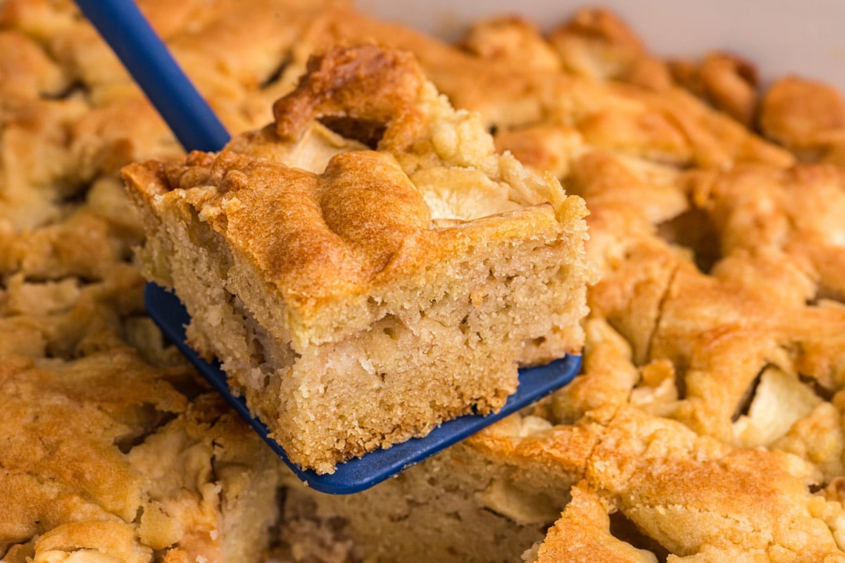 a slice of apple dapple cake on a spatula