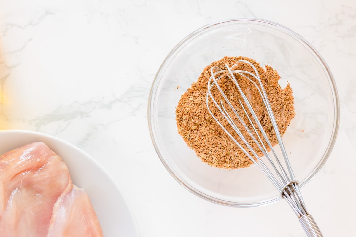 seasonings in a glass bowl with a whisk