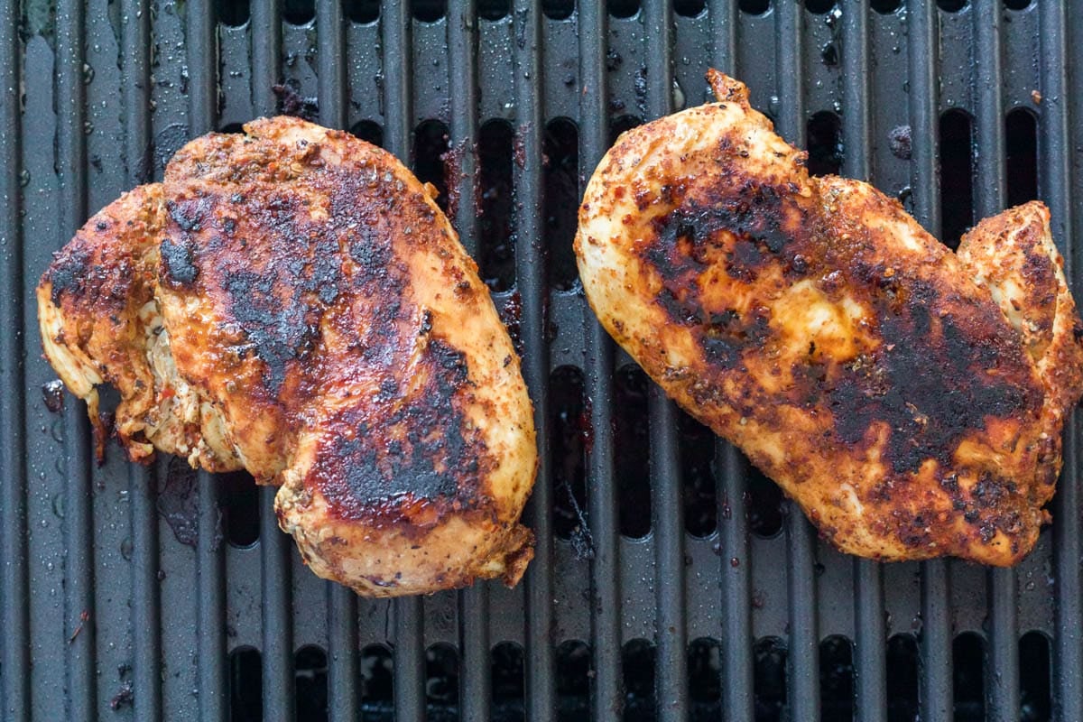 two chicken breasts on a grill