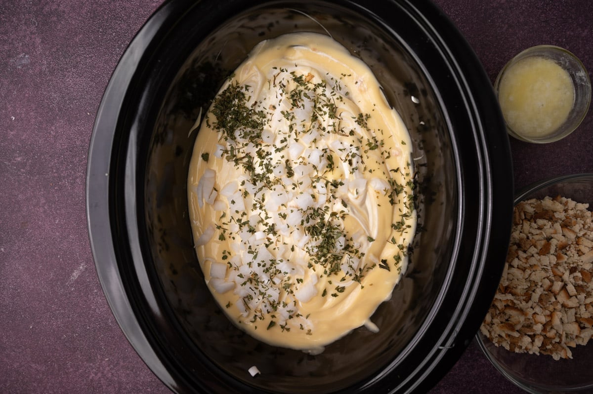 chicken, cream of chicken soup, onions and parsley in a slow cooker