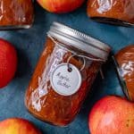 apple butter jars and apples on a table