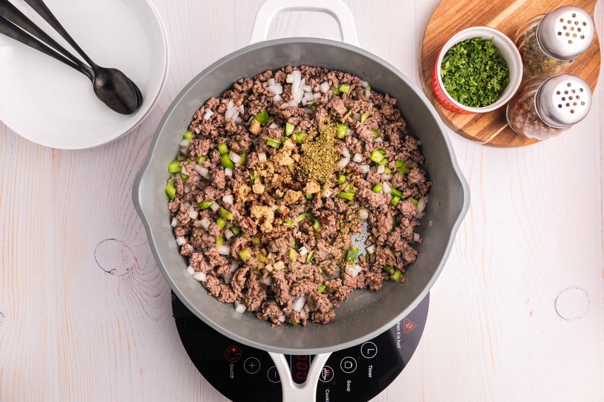 ground beef, onions, peppers and seasonings in a skillet