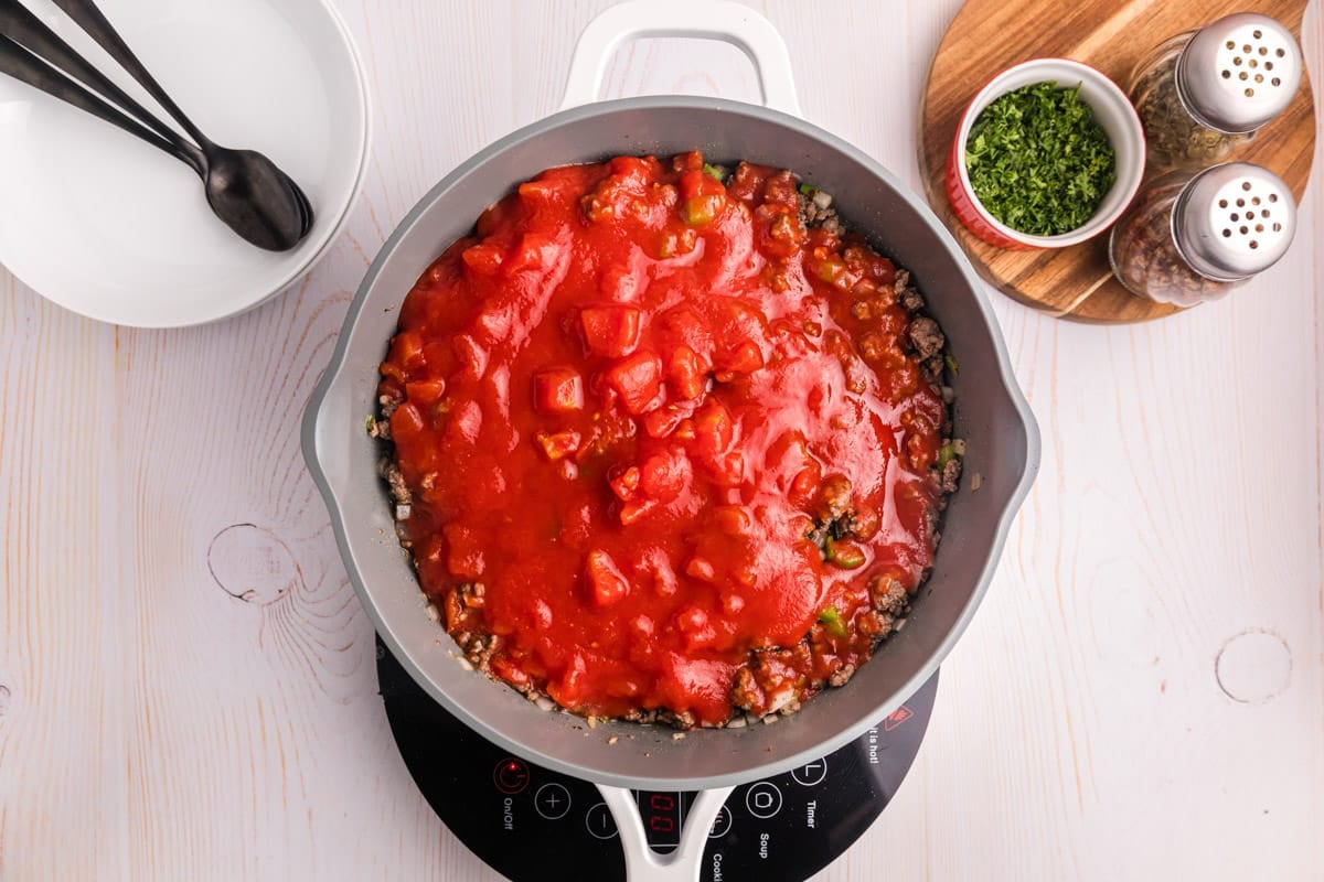 ground beef and tomatoes in a skillet