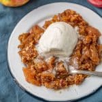 apple crisp with ice cream on a plate with a spoon