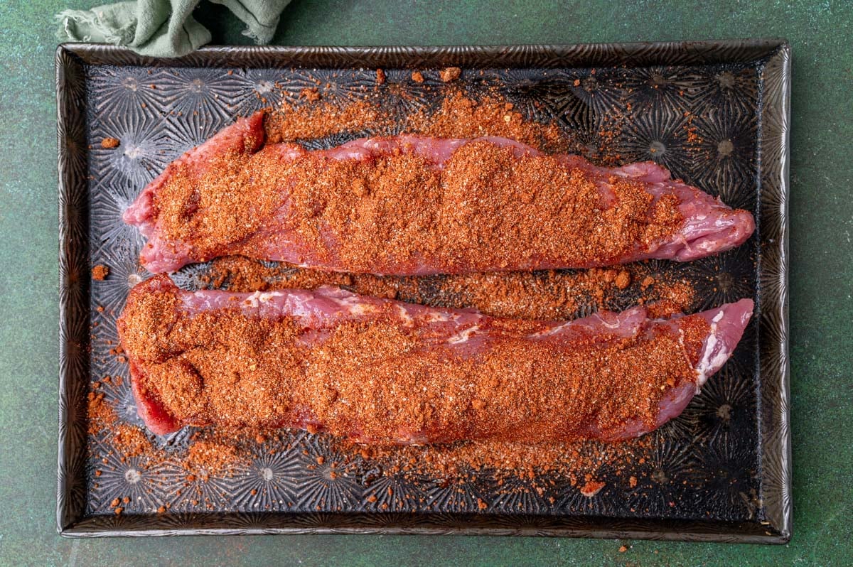 two pork tenderloins with dry rub spices on top