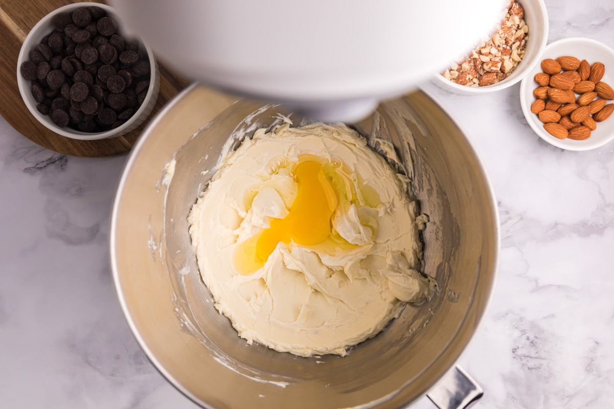 whipped cream cheese with egg over the top in a mixing bowl