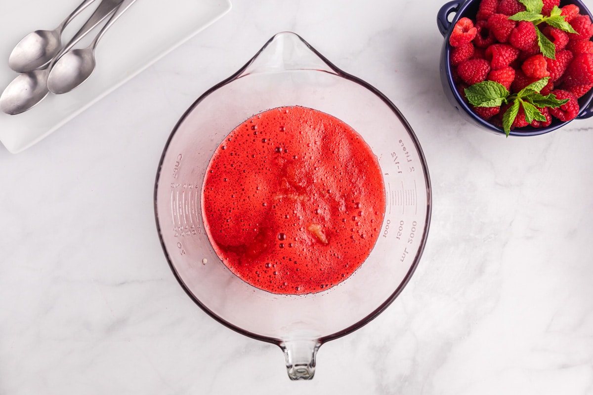 raspberry gelatin with applesauce in a glass bowl