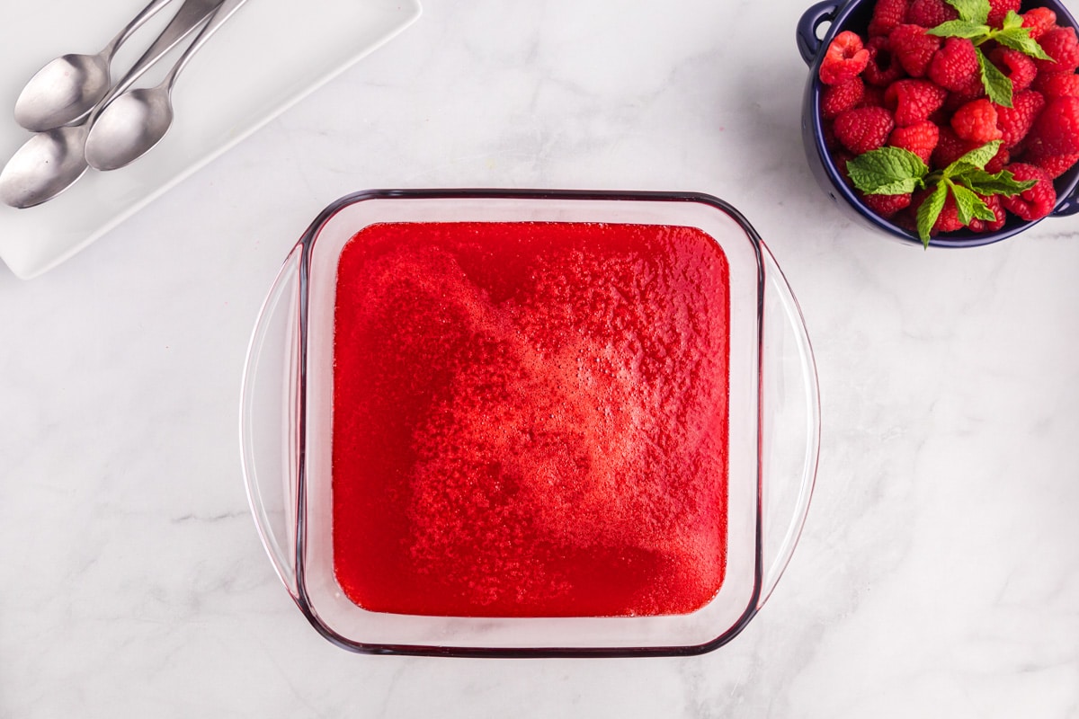 applesauce jello setting in an 8x8" glass baking dish