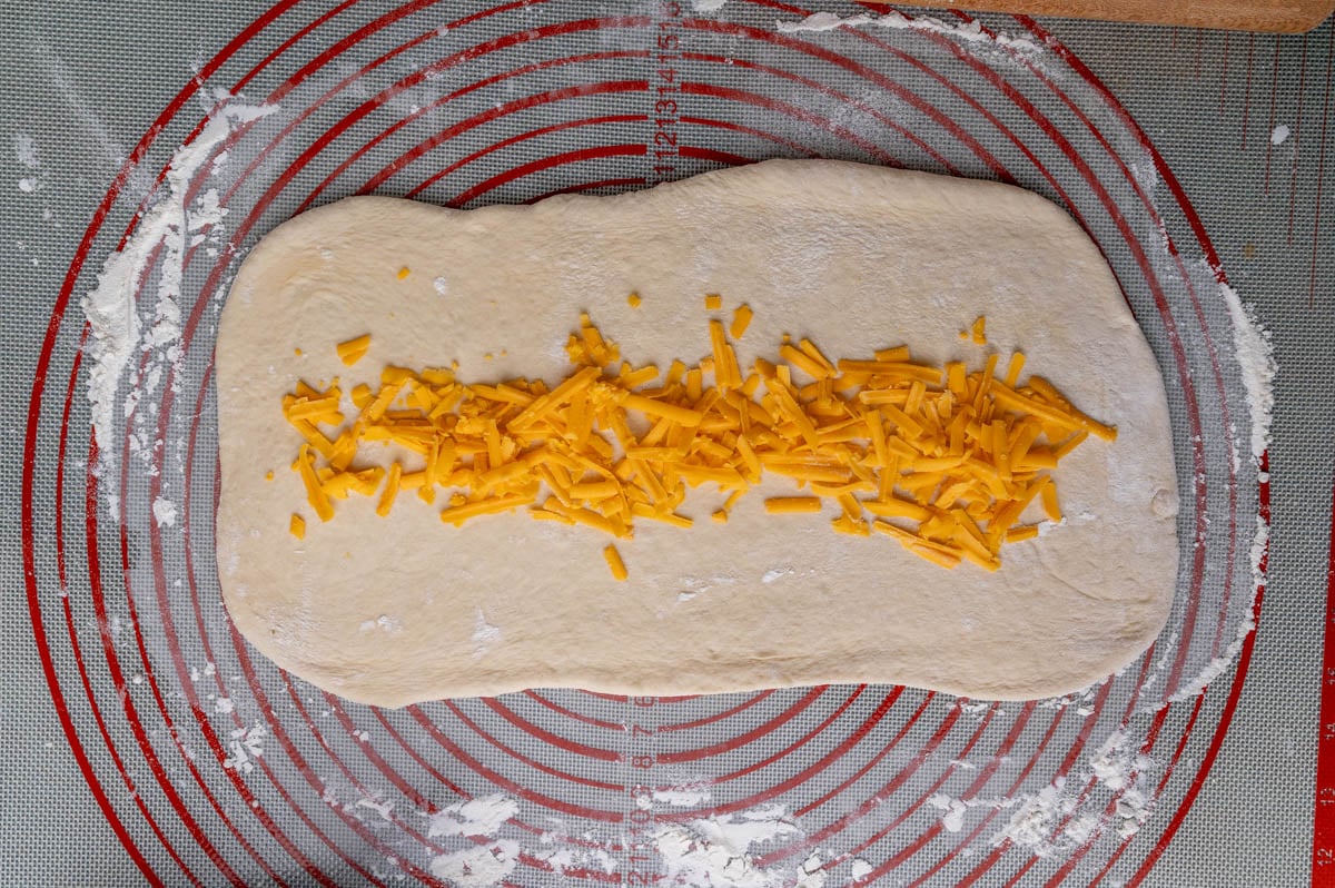 bread dough with shredded cheese on top