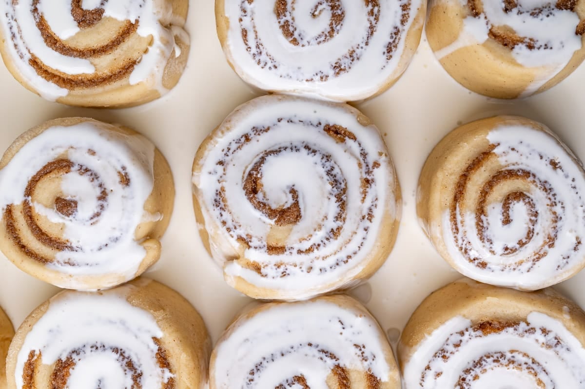 heavy cream poured over unbaked cinnamon rolls