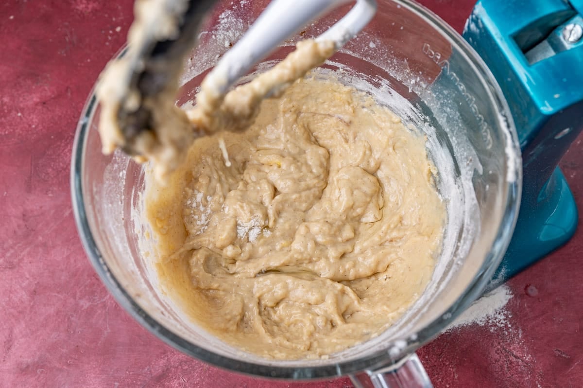 wet cinnamon roll dough in a stand mixer bowl