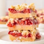 a stack of 3 cherry crumb bars on a plate