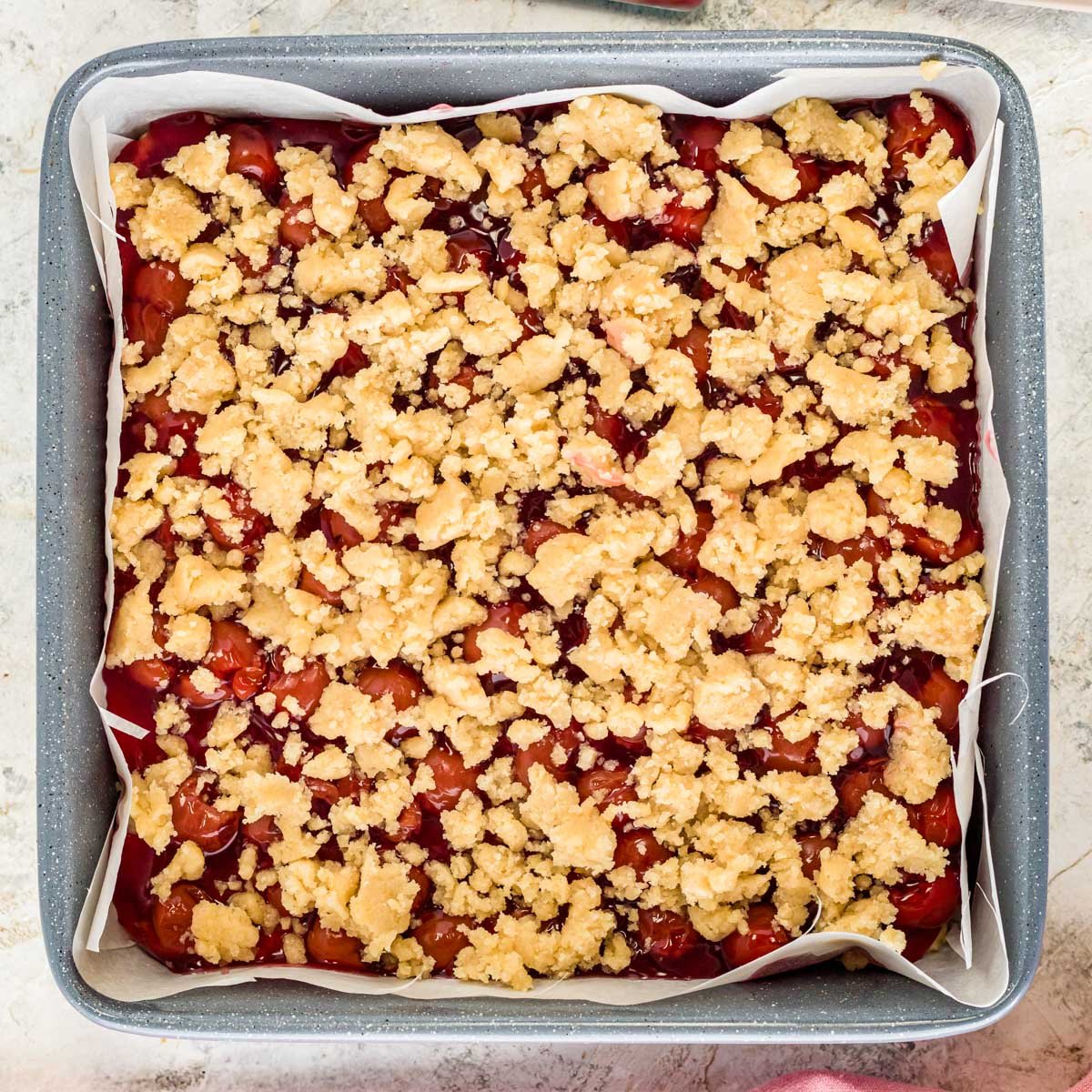 unbaked cherry pie bars with crumb streusel on top